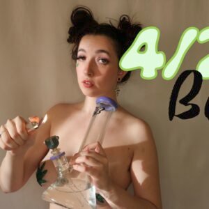 Busty brunette in pot leaf pasties lighting a purple bong title "4/20 Babe"