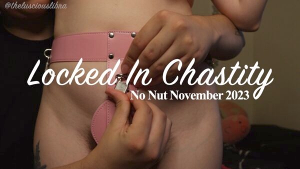 Close up of Kala locking Katherine into a pink chastity belt title "Locked in Chastity: No Nut November 2023"