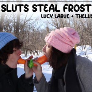 Two brunettes in matching blue and pink knitted hats sharing a double ended carrot in the snowy woods. Title "Snow Sluts Steal Frosty Cock by Lucy LaRue and thelusciouslibra"