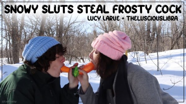 Two brunettes in matching blue and pink knitted hats sharing a double ended carrot in the snowy woods. Title "Snow Sluts Steal Frosty Cock by Lucy LaRue and thelusciouslibra"