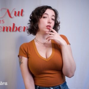 Busty brunette in a tight cropped orange v neck shirt and jeans, red text reads "No Nut November 2025"